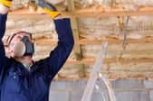 worker installing basement insulation