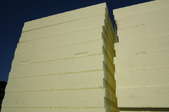 A large stack of thick pieces of foam board insulation.