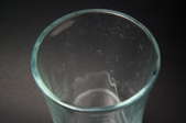 A glass cup with hard water stains.