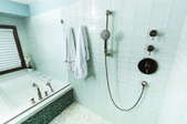 bathroom with wall shower controls