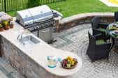 Patio with dinette set and outdoor kitchen