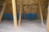 Blown cellulose insulation in an attic.