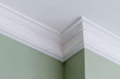 crown molding on green wall at ceiling with jutting corner