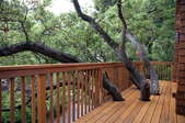 deck with railing surrounded by trees