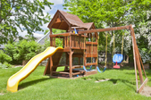 a large wooden swing set with slide