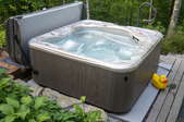 hot tub on a small deck with cover off