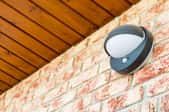 A motion sensor light on a brick home.