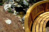 A curved wood bench as part of a deck.