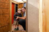 A father and son in a new, backyard playhouse