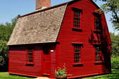 small red house with wide gambrel roof