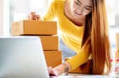 smiling woman selling boxed goods online
