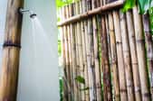 An outdoor shower with bamboo wall