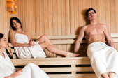 Two women and a men in a sauna.