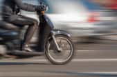 blurring image of rider on a scooter