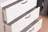 white dresser with three open drawers