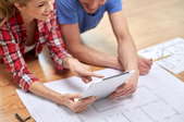 A couple looking at home renovation blueprints.