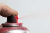 spraying can of red spray paint