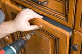 cabinet being repaired with a drill