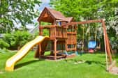 Backyard play structure with slide and swings
