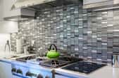 kitchen with metallic tile backsplash