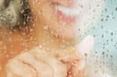 woman in shower with clear wall