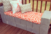 Cement block bench with cushion and pillows
