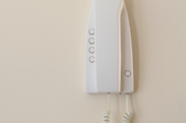 a corded phone mounted to the wall