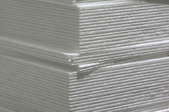 Stack of white foam-core panels.