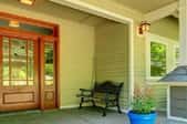 a wood colored fiberglass door on a front porch