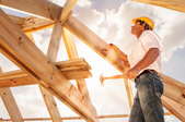 man building house roof frames