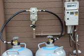 two propane tanks with a connective hose
