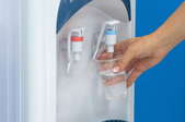 hand getting water from cooler dispenser