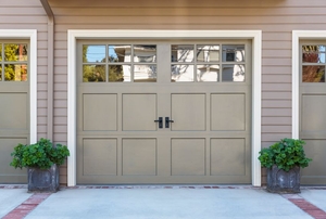 A garage door with windows on the top.