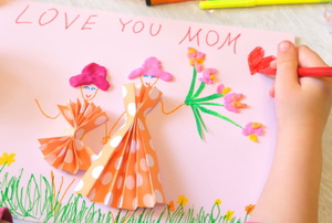 young hand making DIY mother's day card