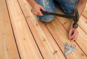 A man works on a deck.
