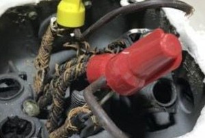 a rusted old wiring fixture with plastic caps
