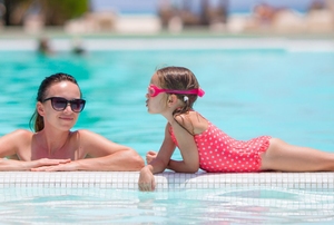 A woman and a girl in a pool.