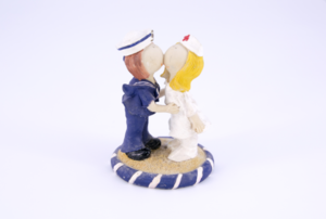 man and woman kissing figurine