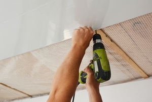 hands drilling plastic ceiling panels
