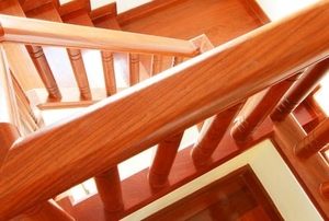 shiny clean wooden banister railing on wooden stairway from above