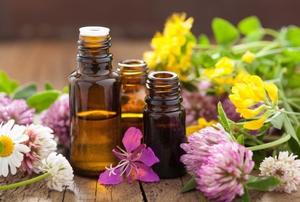 Amber glass bottles surrounded by flowers.