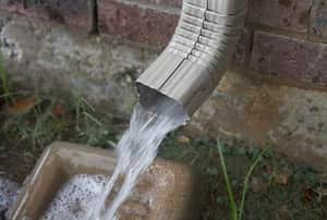 Rain water spilling from a downspout.