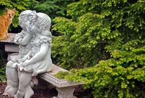 Concrete statues in a garden.