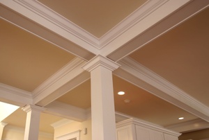 A beige ceiling with crown moldings.
