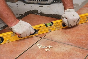 Leveler being used to check the angle of laid outdoor tile