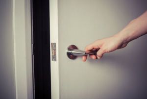 opening a door using a door lever handle.