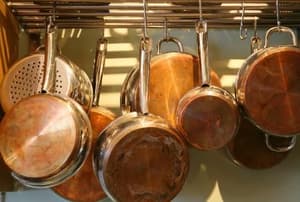 Pots and pans hanging on a rack.