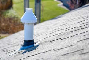 pvc chimney vent on a shingled roof