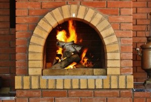 a brick fireplace with burning wood