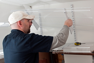 Man installing wire shelving in a closet